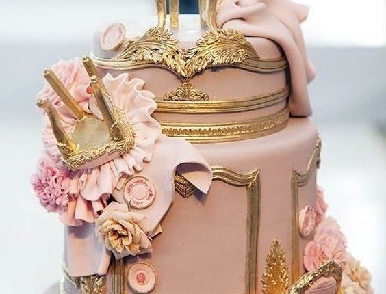 Fondant Louis XIV chairs tumbled down this ornately gilded wedding cake