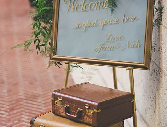 Vintage-inspired suitcase welcome sign decor