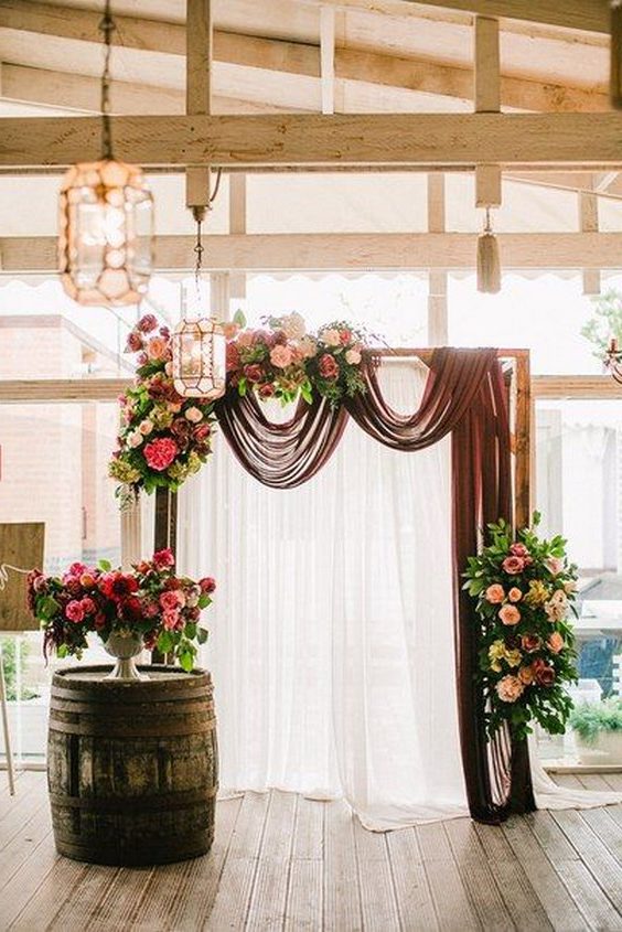 burgundy, blush, or gray draping wedding arch
