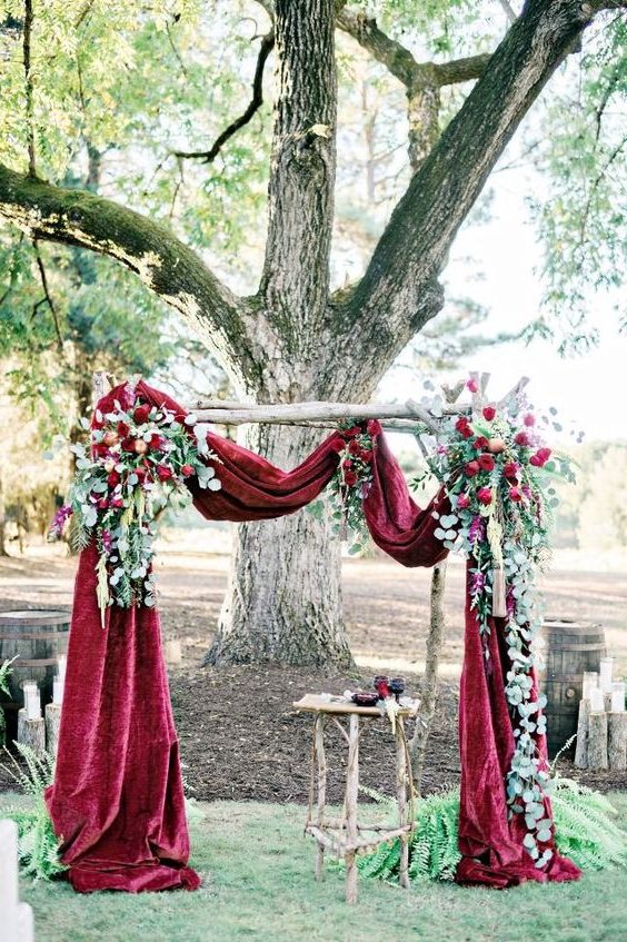 deep red velvet draped wedding arch