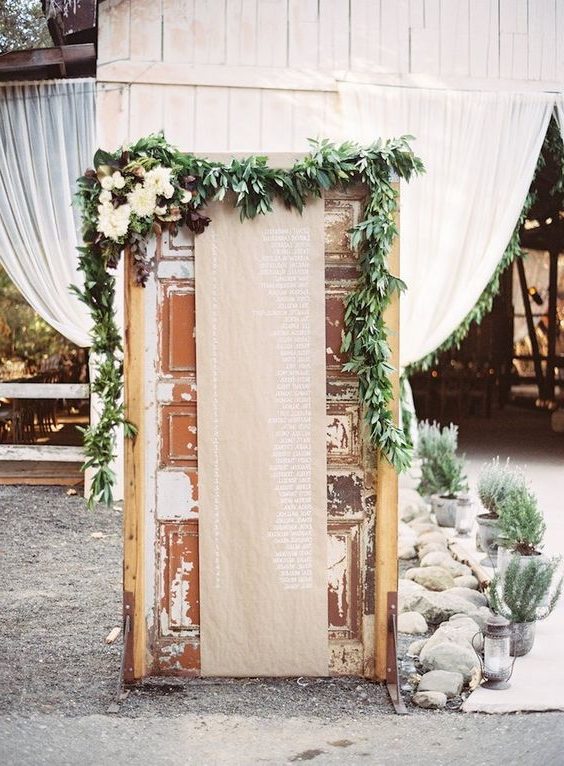 old door seating chart with kraft paper wedding backdrop