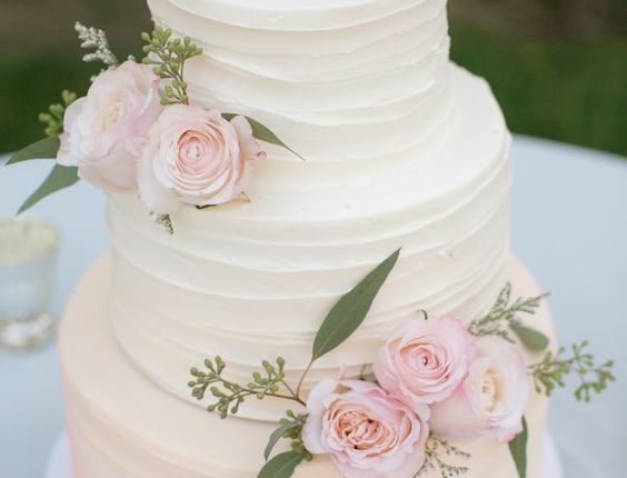 rustic white buttercream wedding cake with pink flwoers