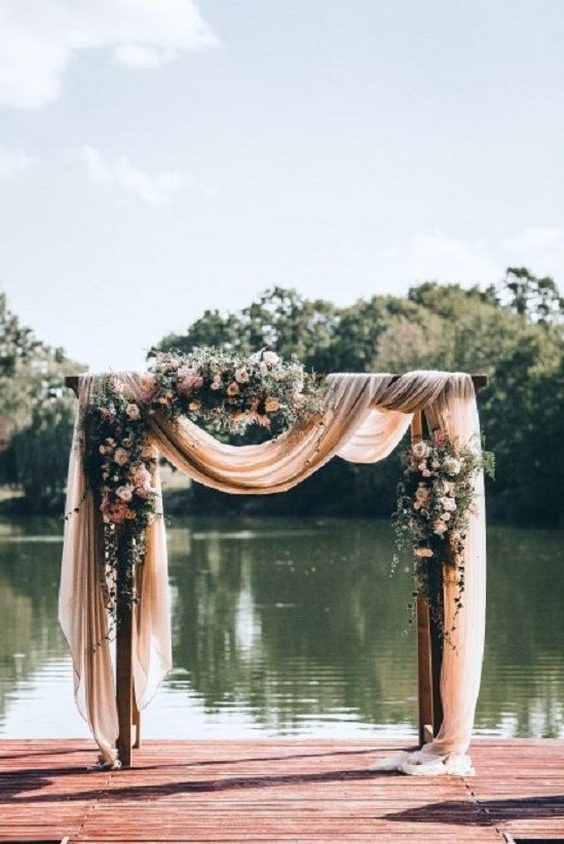 wedding arch with fabric draping + floral