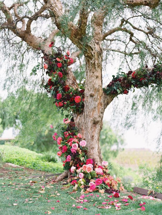 wedding ceremony tree adorned with hundreds of blooms