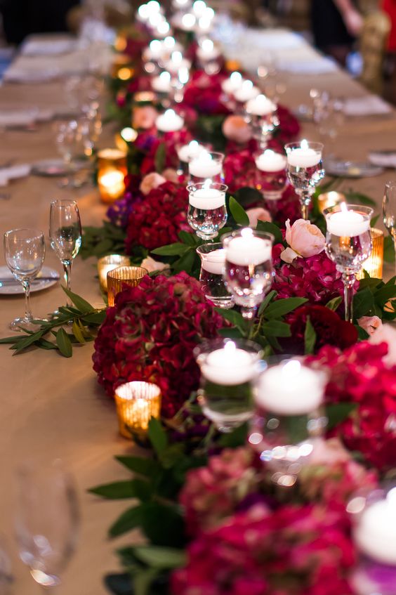 burgundy flowers and floating candles wedding centerpiece