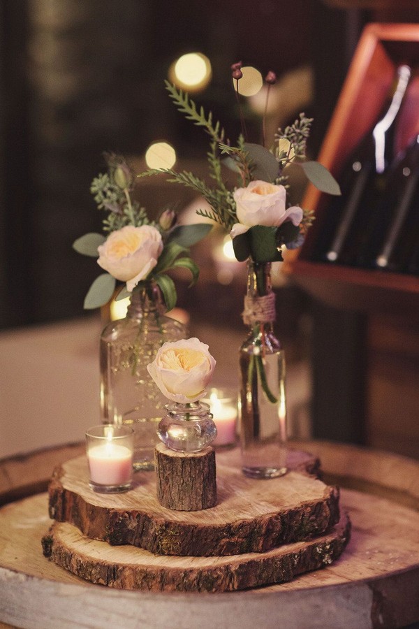 rustic bottles and tree stump wedding centerpiece
