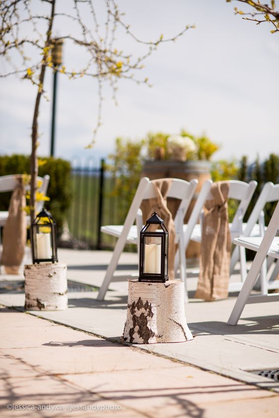 Burlap chair bows, rustic stand with lanterns