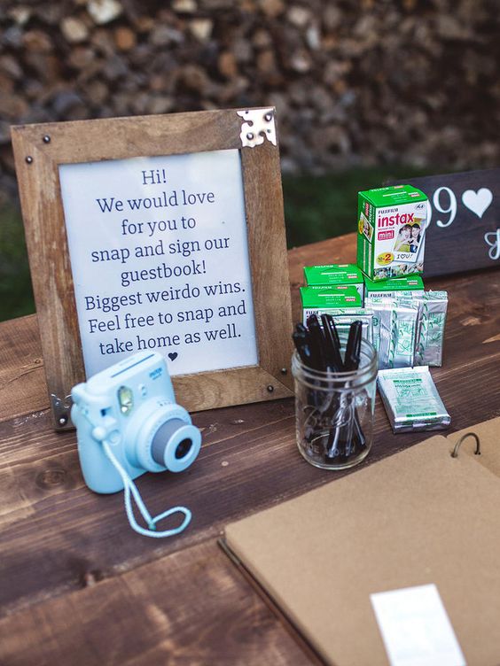 Place a Polaroid camera with film on a rustic table for an alternative approach to the wedding guest book