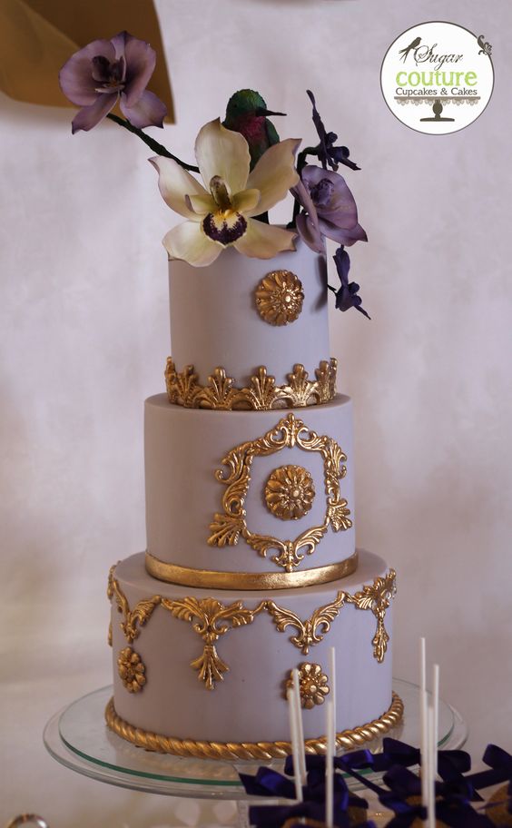 Purple and gold cake. Sugar humming bird and orchids