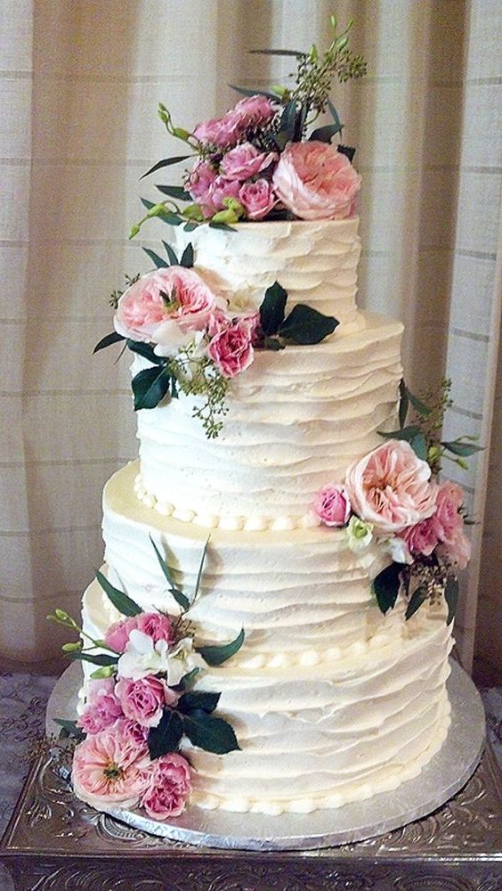 Rustic country old-fashioned wedding cake with pink flowers
