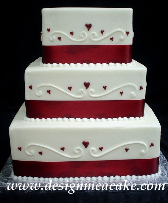 Simple buttercream swirls and hearts square wedding cake