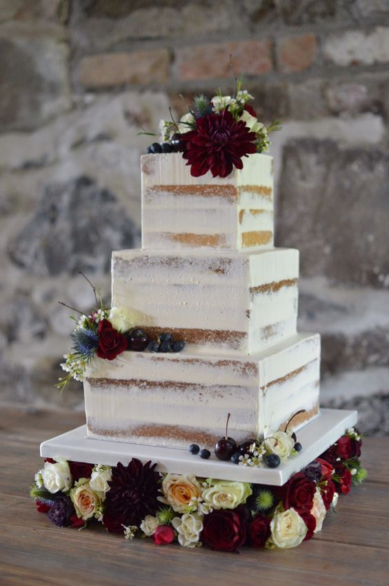 Square semi naked cake on a floral cake stand