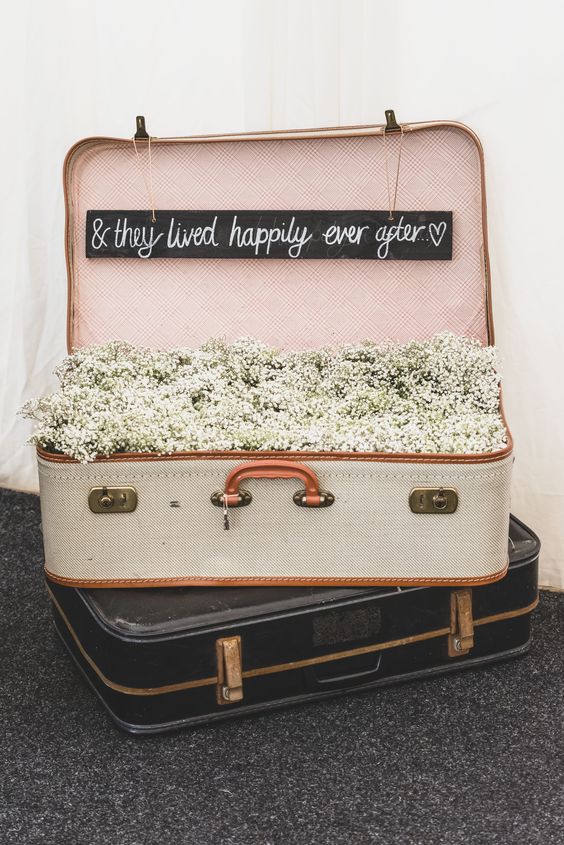 Suitcase filled with gypsophilia wedding decor