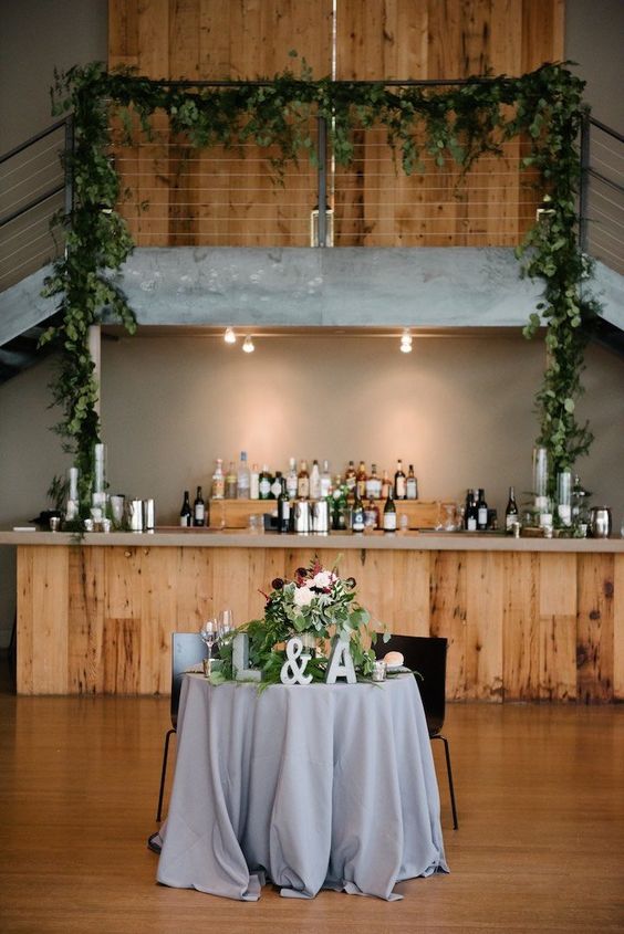 Sweetheart table at the Roundhouse. Staircase greenery at the Roundhouse