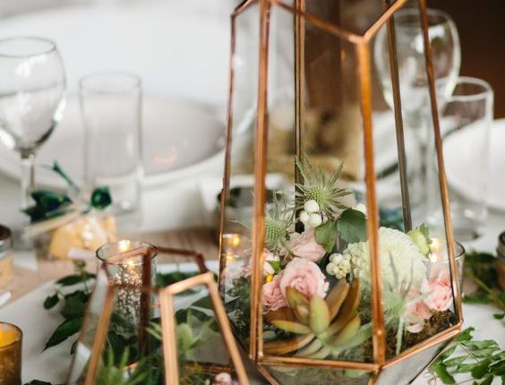 Terrarium centerpiece in mixed metallics with small floral and succulents