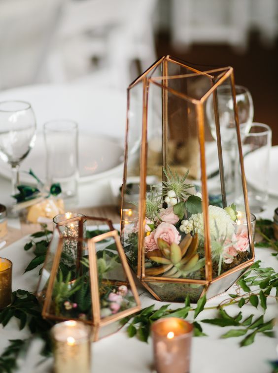 Terrarium centerpiece in mixed metallics with small floral and succulents