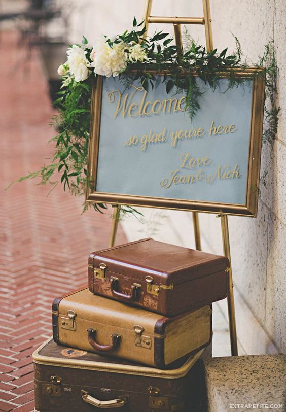 Vintage-inspired suitcase welcome sign decor