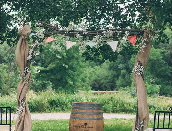 Wedding ceremony arch with bunting and burlap