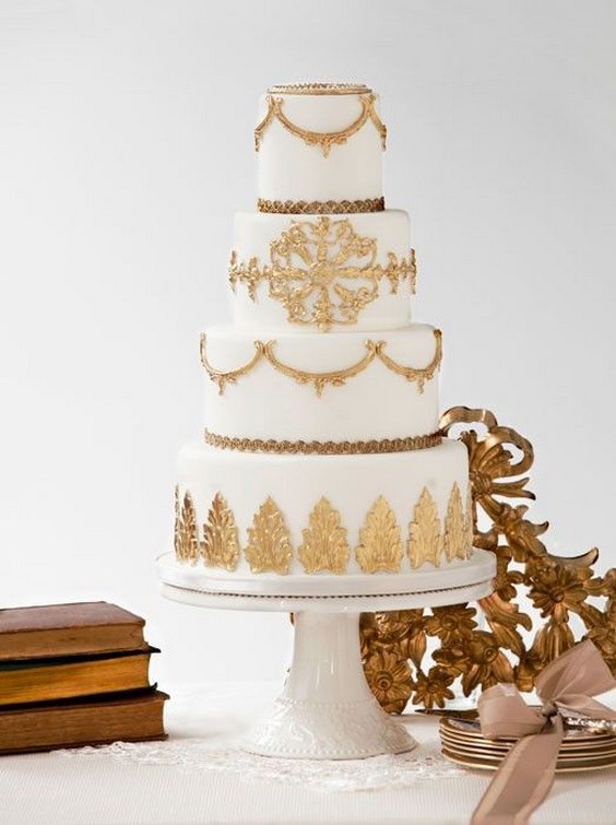 White wedding cake with beautiful gold lace and leaf details