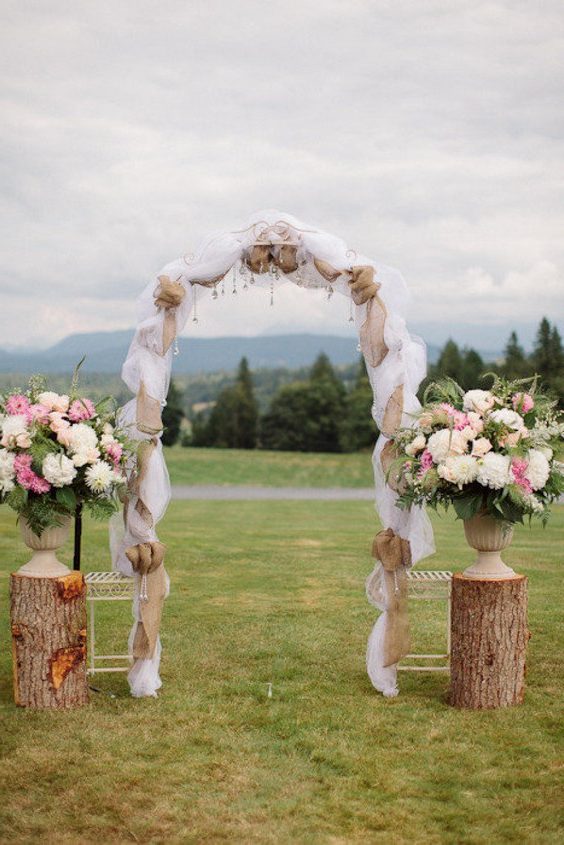 burlap and tree stump wedding arch