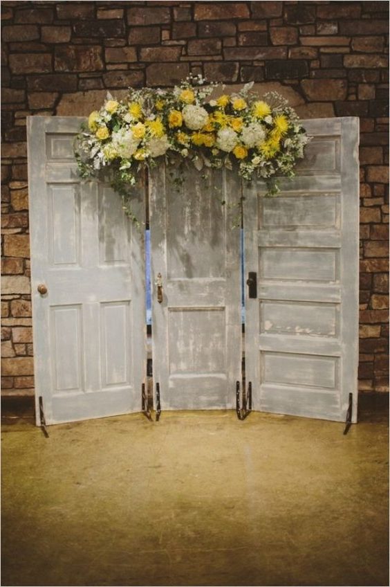 doors with yellow floral arrangement as a ceremony backdrop