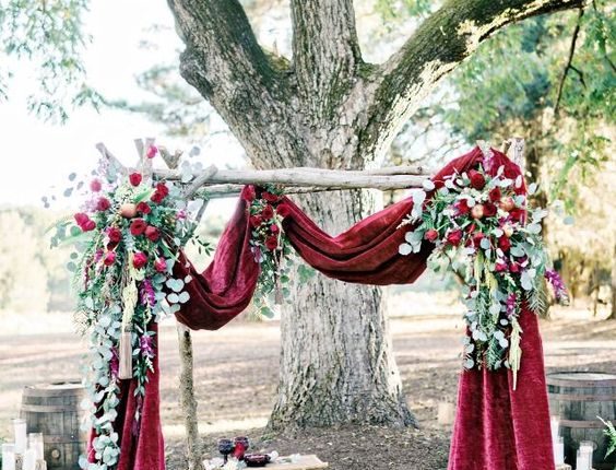 deep red velvet draped wedding arch