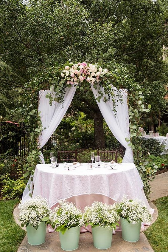 elegant sweetheart table with greenery