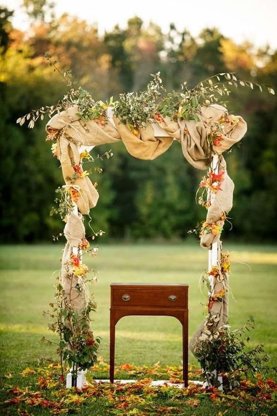 fall wedding arch with leaves and burlap