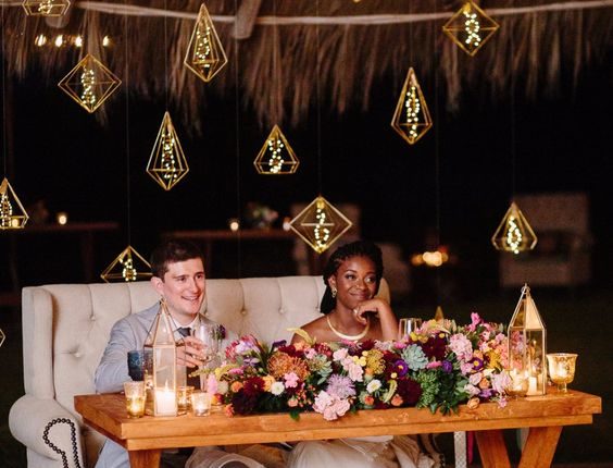 hanging lights behind the sweetheart table