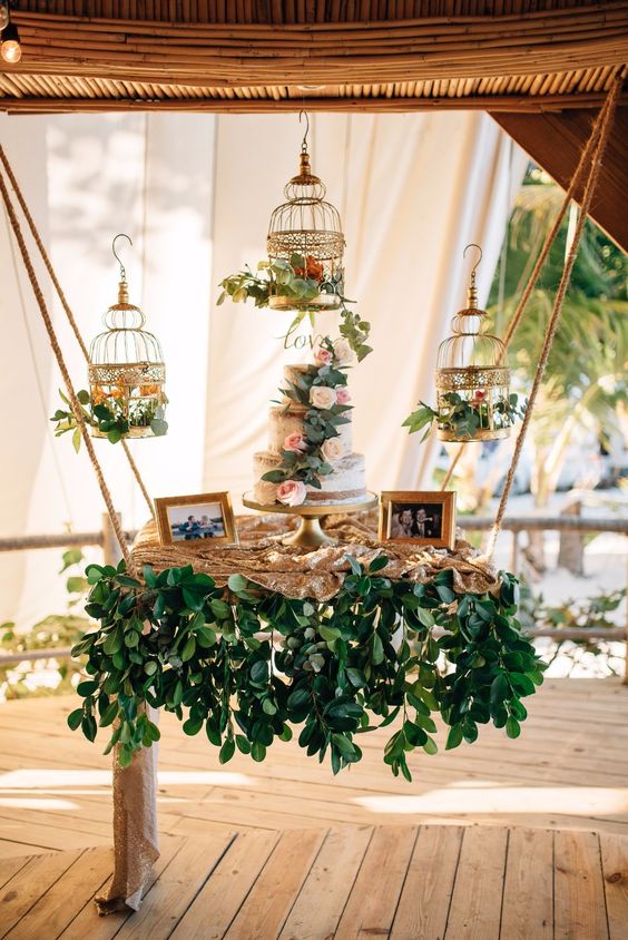 hanging wedding cake table with vintage birdcages and cascading vines