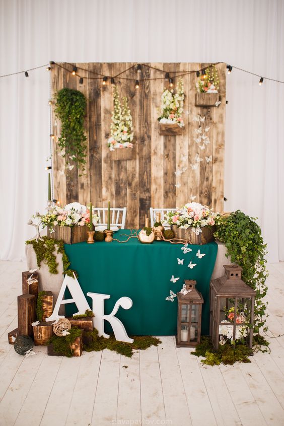 rustic moss and wooden pallet head sweetheart table decor