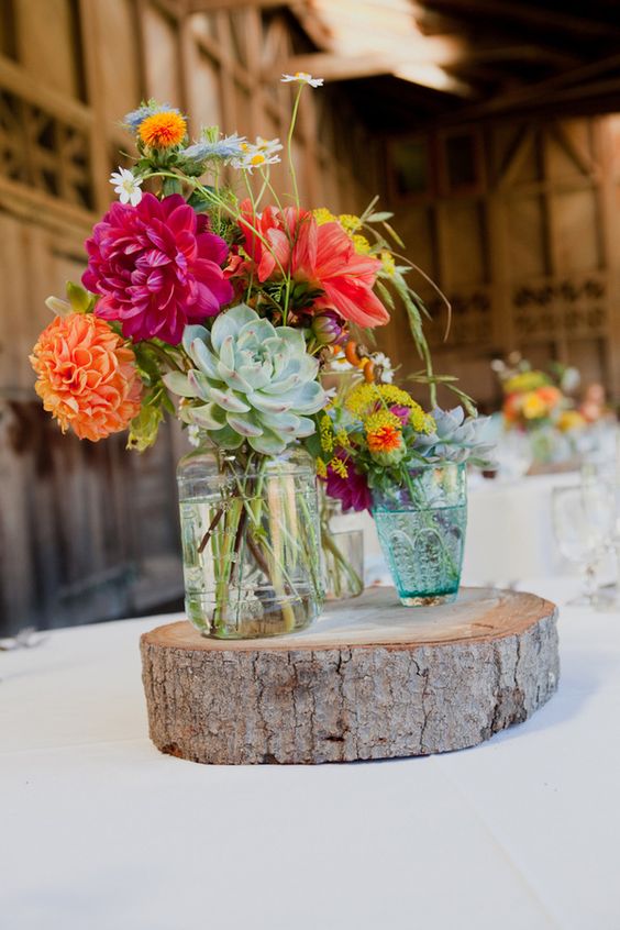 rustic tree stump and succulent wedding centerpiece