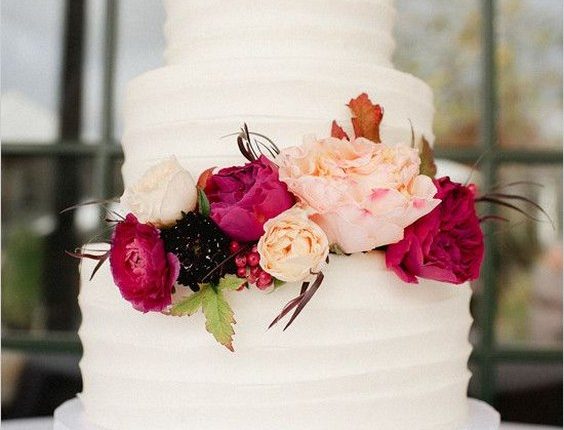 rustic white buttercream wedding cake with deep red flwoers