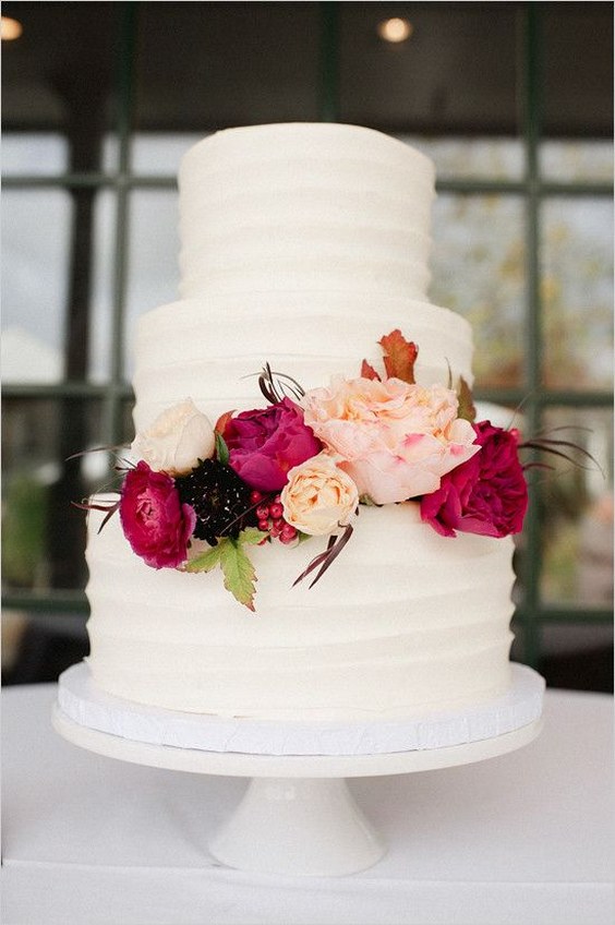 rustic white buttercream wedding cake with deep red flwoers