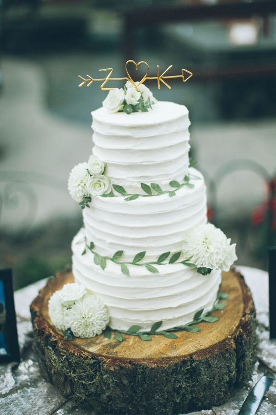 rustic white buttercream wedding cake with greenery sugar leaves