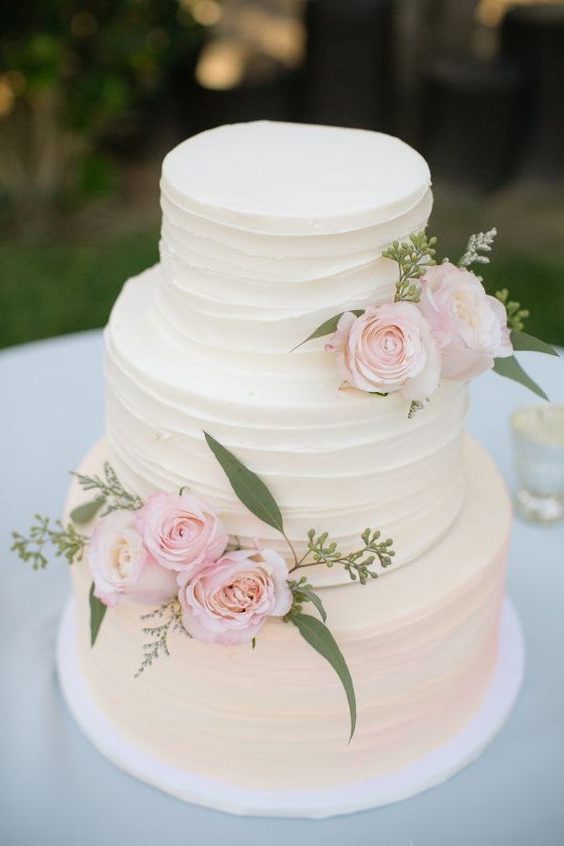 rustic white buttercream wedding cake with pink flwoers