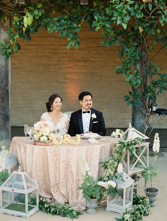 rustic wood lanterns and greenery wedding head table decor
