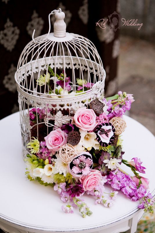 vintage birdcage and purple flowers wedding decor