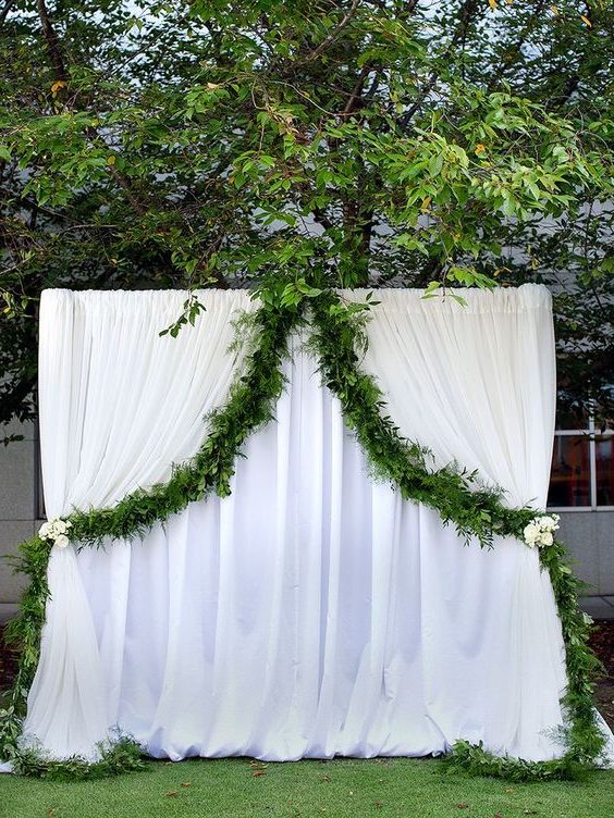 white curtain arch with simple draped garland