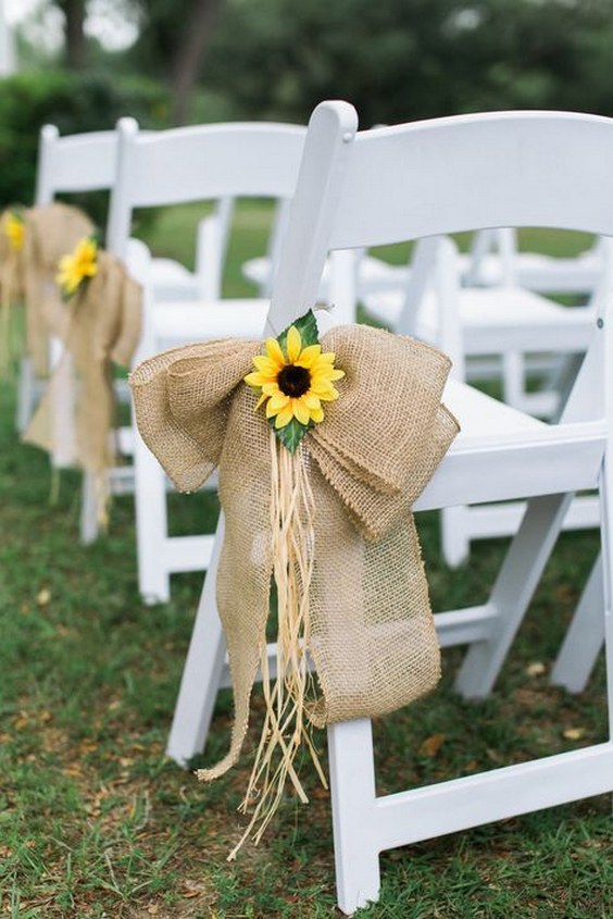 wite wedding chairs were paired with large burlap bows and sunflower