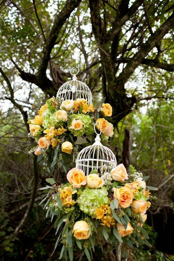 yellow roses and white birdcages hanging wedding decor