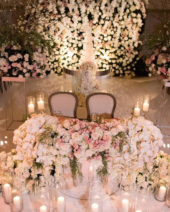 luxury ivory roses and candle wedding sweetheart table