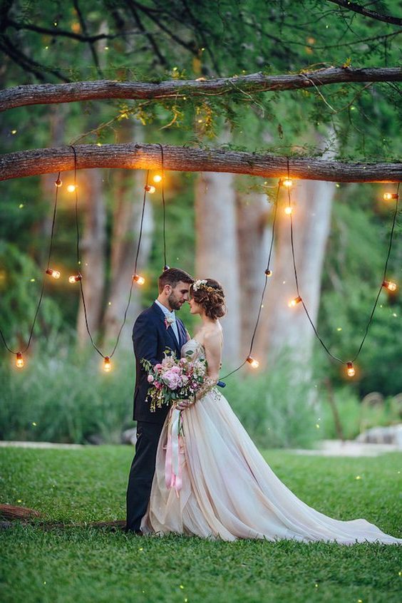Whimsical tree wedding backdrop with bistro lights