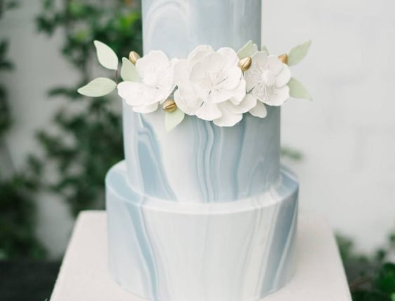 Blue Grey and White Marble Three Tiered Minimalist Wedding Cake with Ivory Sugar Flowers with Green Leaf Accent