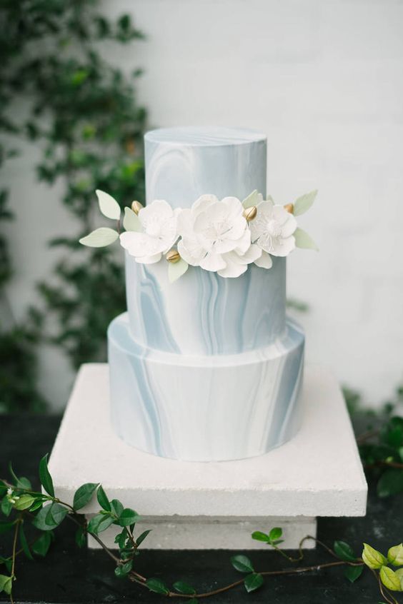 Blue Grey and White Marble Three Tiered Minimalist Wedding Cake with Ivory Sugar Flowers with Green Leaf Accent
