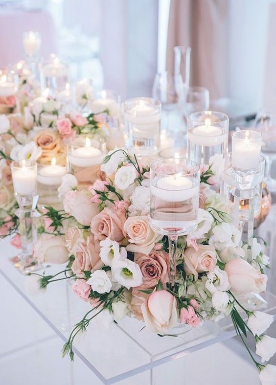 blush dusty roses and candles wedding centerpiece