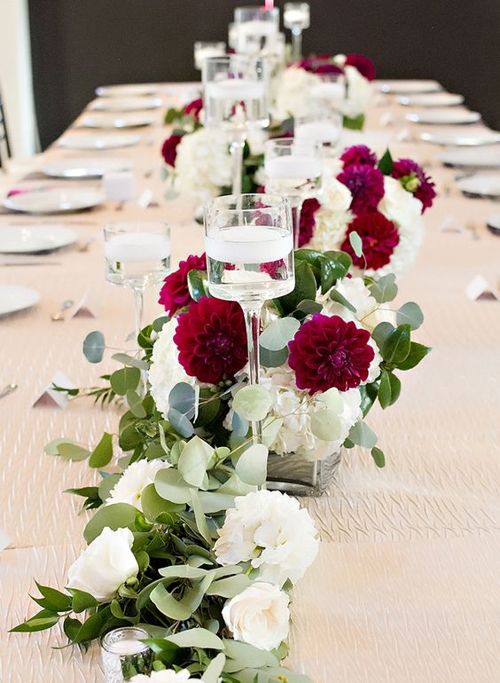 burgundy greenery and floating candles wedding centerpiece