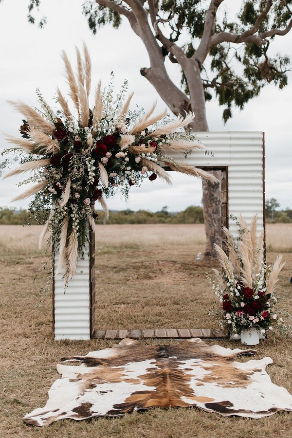 boho pampas grass burgundy roses and greenery fall wedding arch