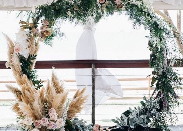 pampas grass and greenery wreath wedding backdrop