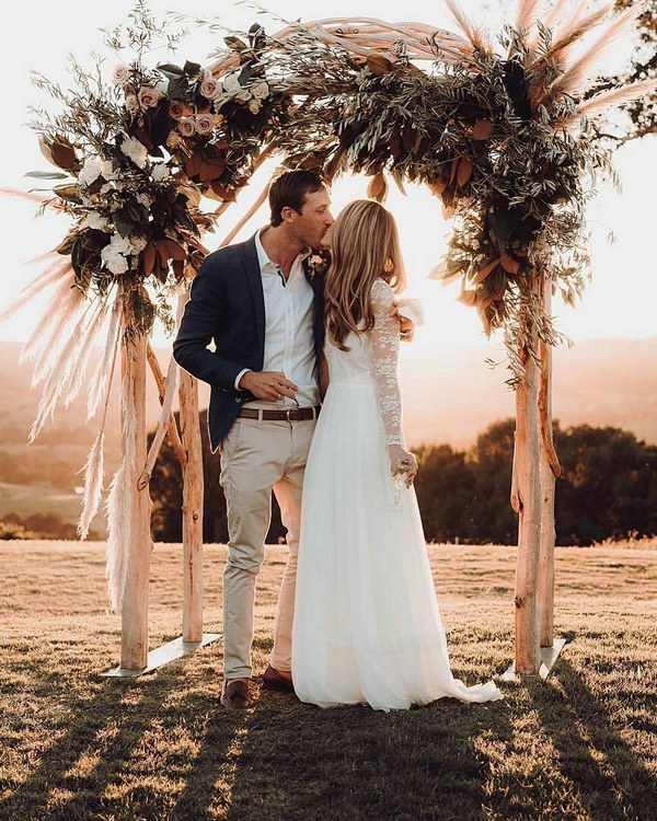 rustic boho pampas grass and roses wedding arch alter
